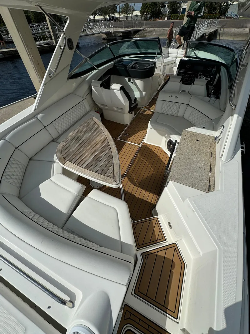 Slide: The Image of 2015 Sea Ray 350 SLX boat interior with white seating and wooden flooring. - 3