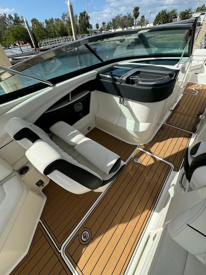 Slide: The Image of 2015 Sea Ray 350 SLX boat interior with sleek seating and wooden flooring. - 4