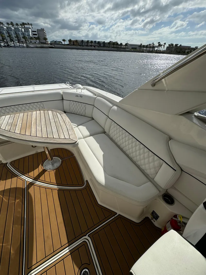 Slide: The Image of Luxurious 2015 Sea Ray 350 SLX boat with elegant seating and scenic waterfront view. - 5