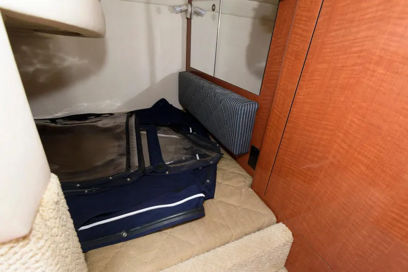 Slide: The Image of 2005 Sea Ray 280 Sundancer cabin interior with storage and luggage. - 10