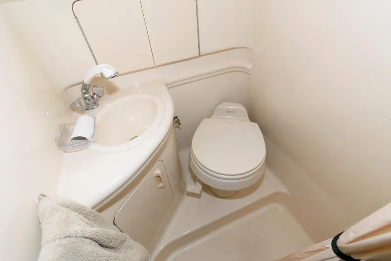 Slide: The Image of Compact bathroom in 2005 Sea Ray 280 Sundancer boat with sink and toilet. - 11