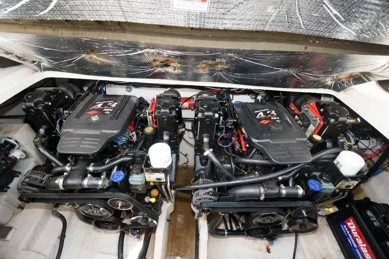 Slide: The Image of Twin engines of a 2005 Sea Ray 280 Sundancer boat, showcasing detailed mechanics. - 12