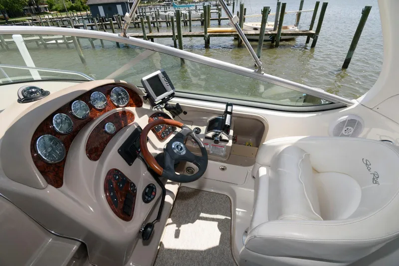 Slide: The Image of Helm of 2005 Sea Ray 280 Sundancer with gauges, steering wheel, and controls. - 4