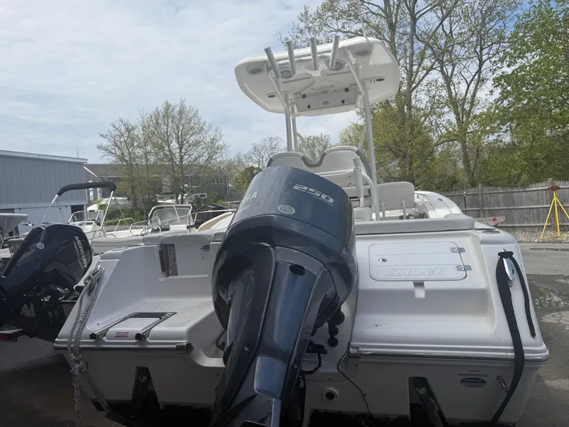 Slide: The Image of 2015 Tidewater 230 LXF boat with outboard motor, parked outdoors. - 8