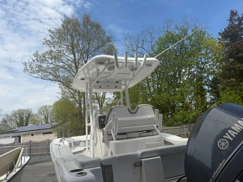Slide: The Image of 2015 Tidewater 230 LXF boat with Yamaha engine, parked outdoors under a clear sky. - 9