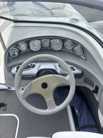 Slide: The Image of 2006 Bayliner 205 MX boat dashboard with steering wheel and gauges. - 12