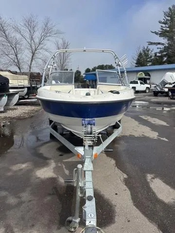 Slide: The Image of 2006 Bayliner 205 MX boat on trailer, parked outdoors on a cloudy day. - 3