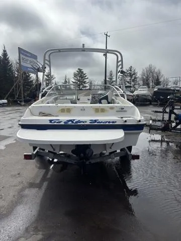 Slide: The Image of 2006 Bayliner 205 MX boat in a parking lot, rear view, overcast sky. - 6