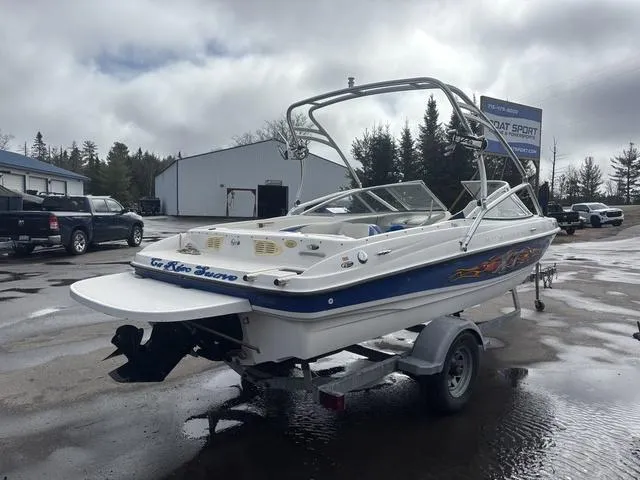 Slide: The Image of 2006 Bayliner 205 MX boat on trailer, parked outdoors on a cloudy day. - 7