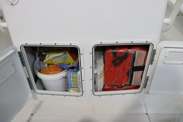Slide: The Image of Storage compartments on a 2007 Everglades 223CC boat, containing safety gear and supplies. - 13