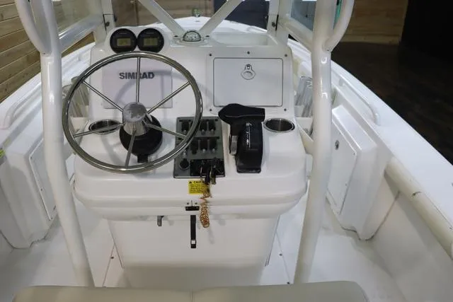 Slide: The Image of Center console of a 2007 Everglades 223CC boat with steering wheel and controls. - 14
