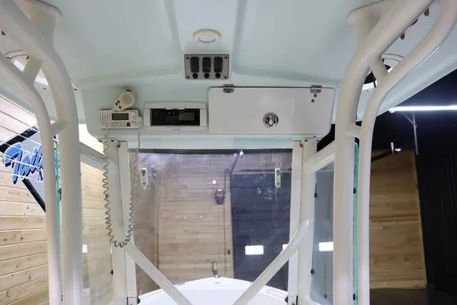 Slide: The Image of Interior view of a 2007 Everglades 223CC boat, showcasing the helm and storage compartments. - 15