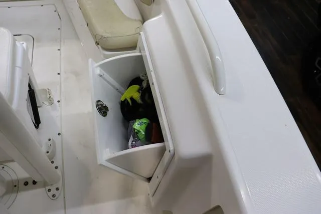 Slide: The Image of 2007 Everglades 223CC boat interior with open storage compartment and visible items. - 16