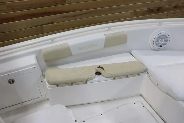 Slide: The Image of 2007 Everglades 223CC boat interior with worn seating and speaker. - 18