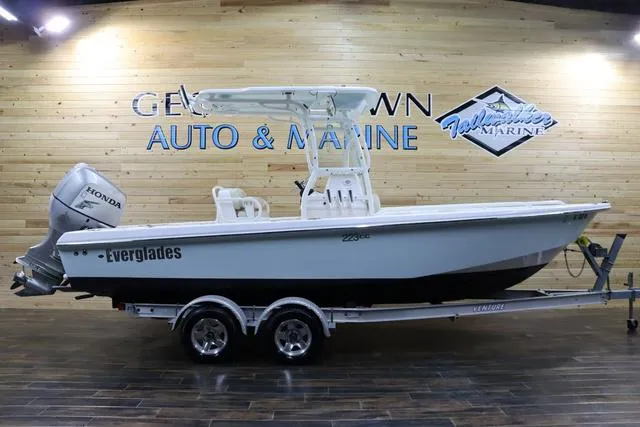 Slide: The Image of 2007 Everglades 223CC boat on trailer, displayed indoors at an auto and marine showroom. - 2