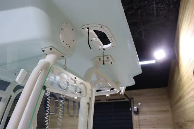 Slide: The Image of 2007 Everglades 223CC boat interior, featuring overhead compartments and modern design elements. - 23