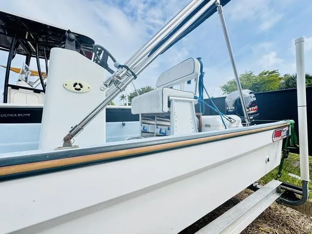 Slide: The Image of 2017 Panga 25 boat with outboard motor, docked on a trailer under a clear sky. - 2