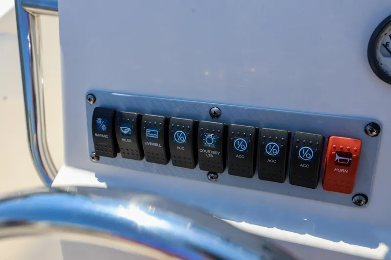Slide: The Image of Control panel of a 2016 Key West 176 Center Console boat with labeled switches. - 11