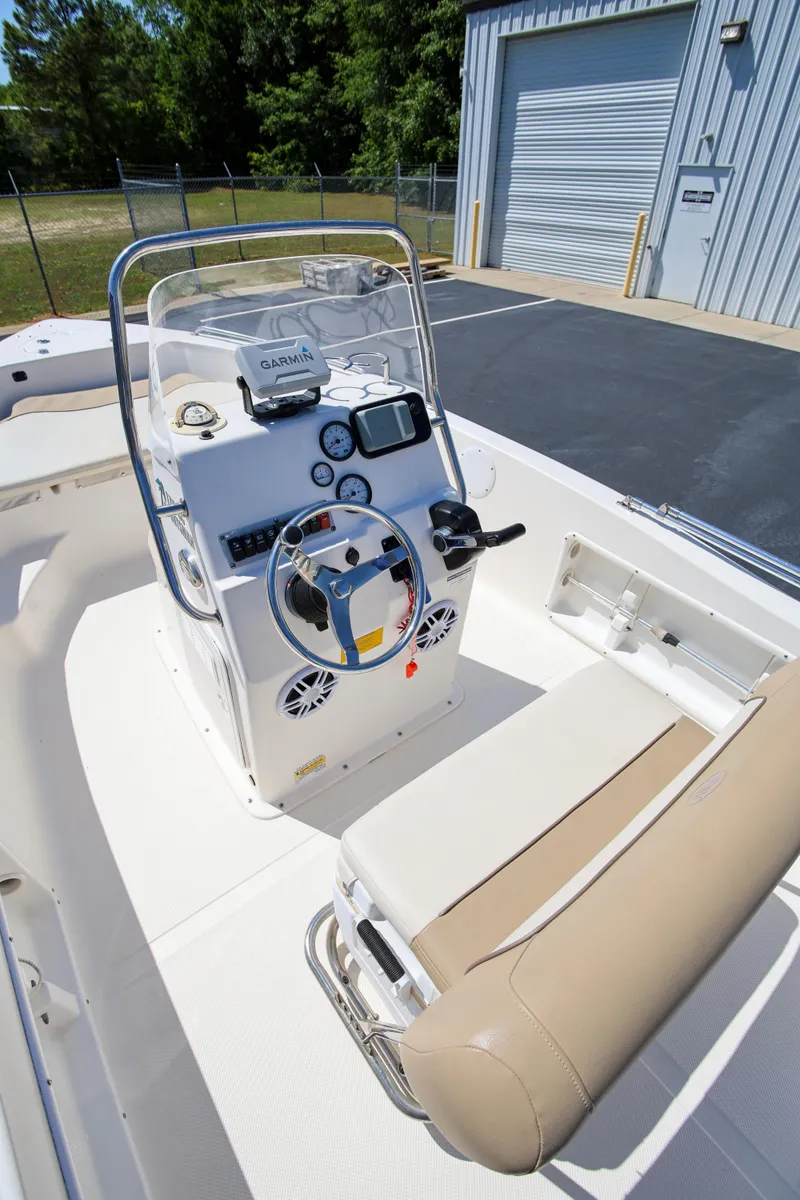 Slide: The Image of 2016 Key West 176 Center Console boat interior with steering wheel and navigation equipment. - 12