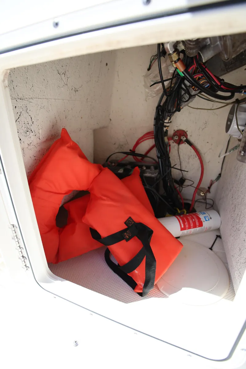 Slide: The Image of Storage compartment of 2016 Key West 176 Center Console with life jackets and fire extinguisher. - 14