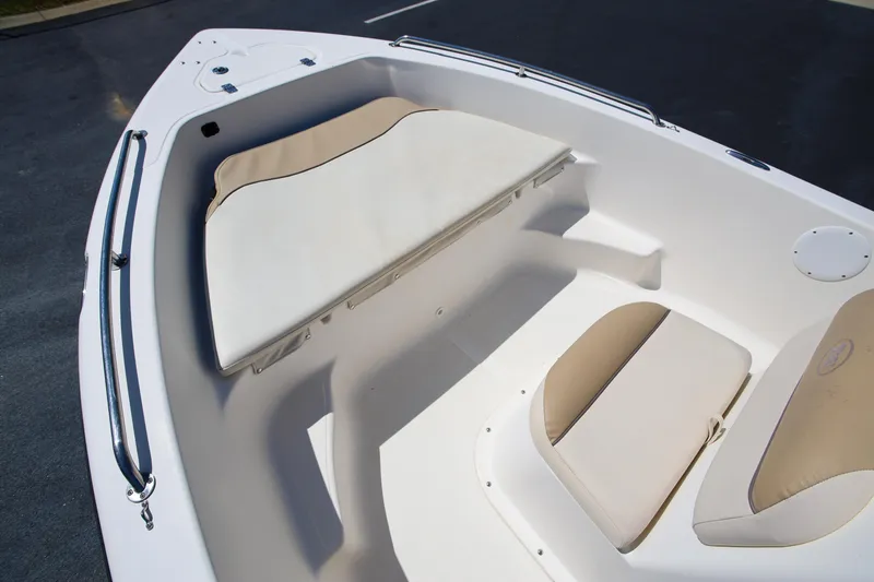 Slide: The Image of 2016 Key West 176 Center Console boat interior with beige seating and white deck. - 15