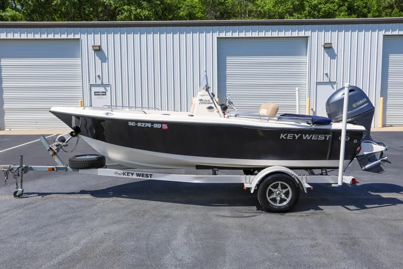 Slide: The Image of 2016 Key West 176 Center Console boat on trailer, parked outside storage facility. - 4