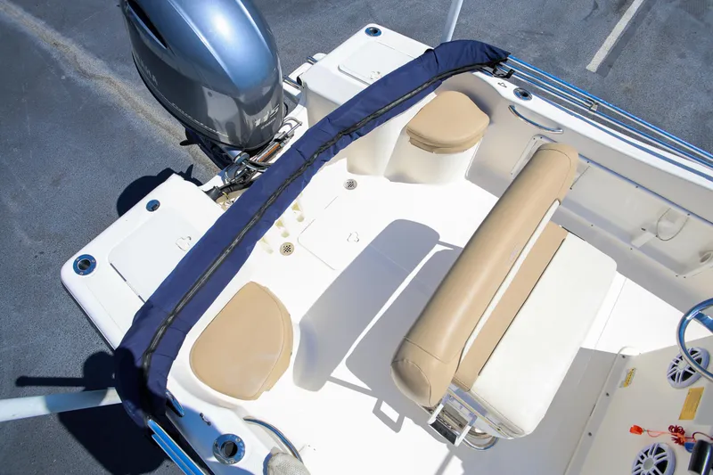 Slide: The Image of 2016 Key West 176 Center Console boat interior with seating and motor. - 5