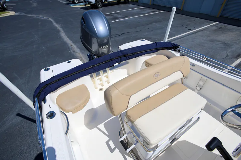 Slide: The Image of 2016 Key West 176 Center Console boat interior with Yamaha 115 engine in parking lot. - 6