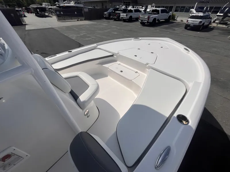 Slide: The Image of 2020 Tidewater 2210 Carolina Bay boat with spacious seating and storage, parked outdoors. - 10