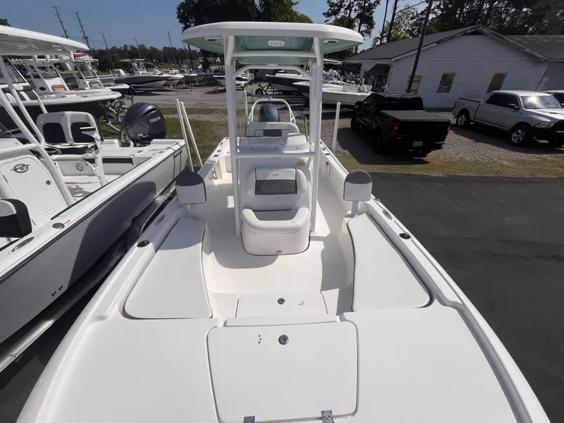 Slide: The Image of 2020 Tidewater 2210 Carolina Bay boat, white interior, parked outdoors. - 11
