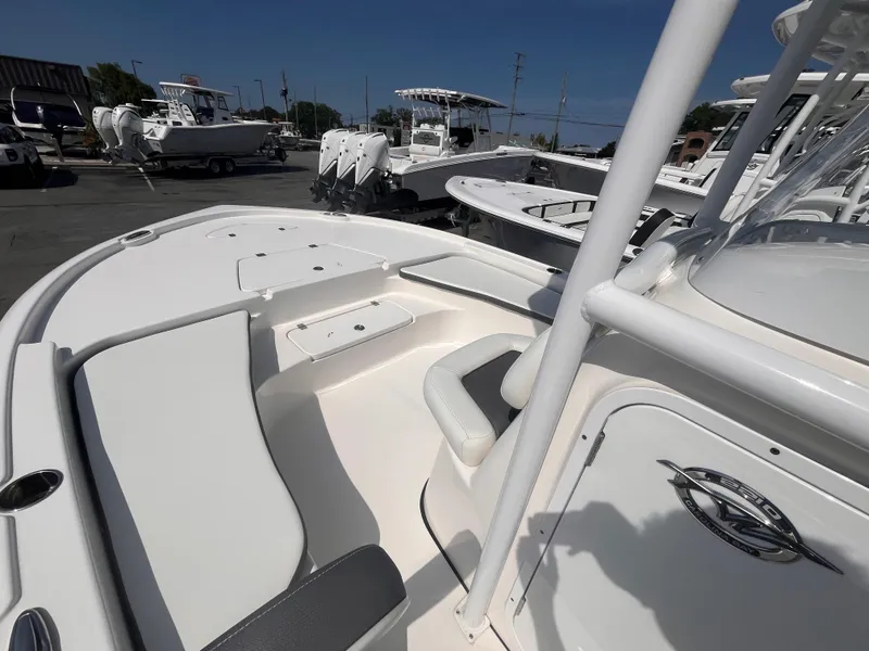 Slide: The Image of 2020 Tidewater 2210 Carolina Bay boat interior with seating and console, displayed outdoors. - 12