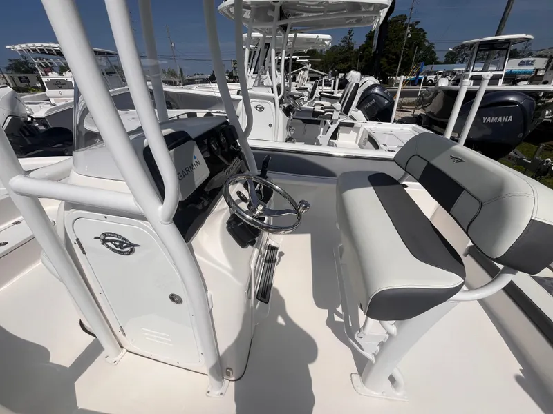 Slide: The Image of 2020 Tidewater 2210 Carolina Bay boat interior with steering wheel and seating. - 13