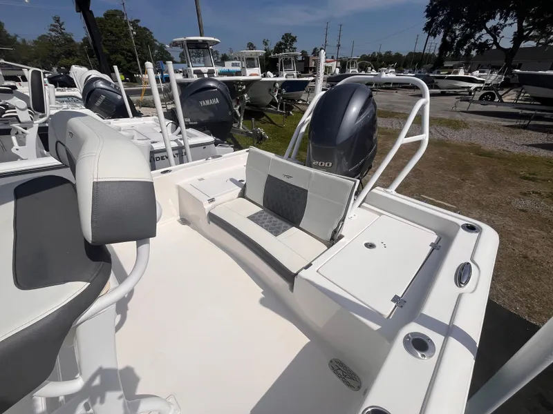 Slide: The Image of 2020 Tidewater 2210 Carolina Bay boat with seating and motor, displayed outdoors. - 14