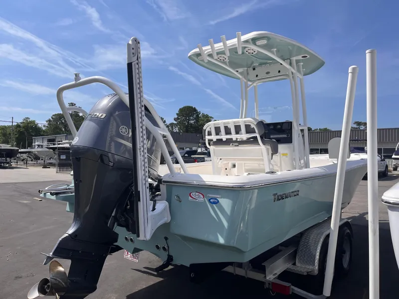 Slide: The Image of 2020 Tidewater 2210 Carolina Bay boat on trailer, featuring a powerful outboard motor. - 4
