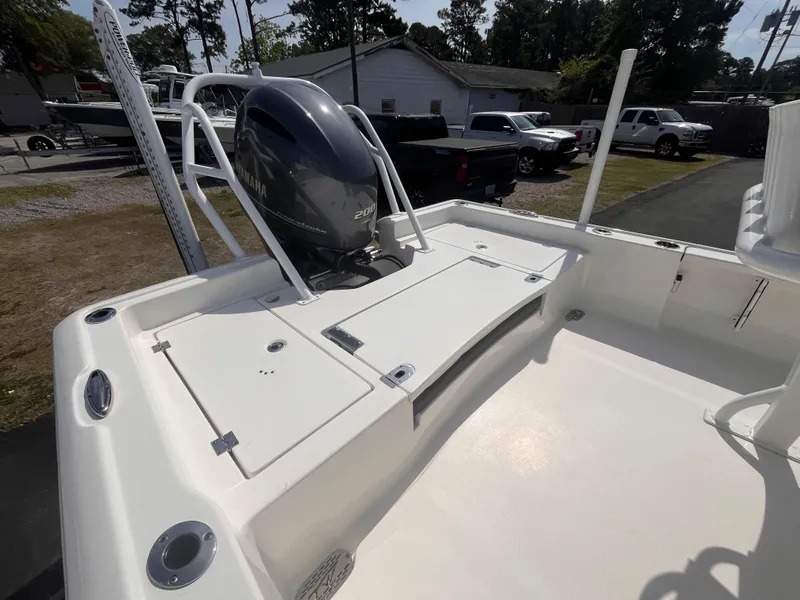 Slide: The Image of 2020 Tidewater 2210 Carolina Bay boat with Yamaha outboard motor, parked outdoors. - 5