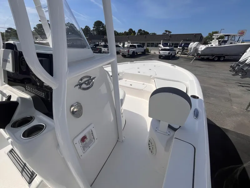 Slide: The Image of 2020 Tidewater 2210 Carolina Bay boat, white interior, parked in a marina. - 9