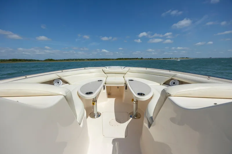 Slide: The Image of 2015 Grady-White Freedom 375 boat interior with seating, tables, and ocean view. - 10