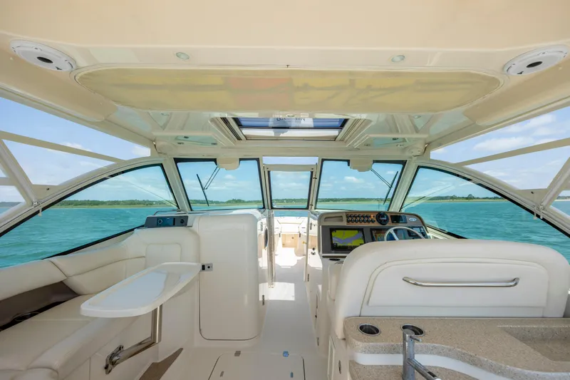 Slide: The Image of Interior view of 2015 Grady-White Freedom 375 boat with luxurious seating and ocean backdrop. - 11