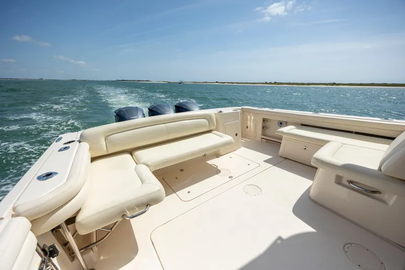 Slide: The Image of 2015 Grady-White Freedom 375 boat with spacious seating on open water. - 14