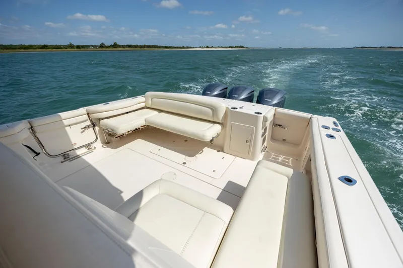 Slide: The Image of 2015 Grady-White Freedom 375 boat cruising on open water, featuring spacious seating. - 15