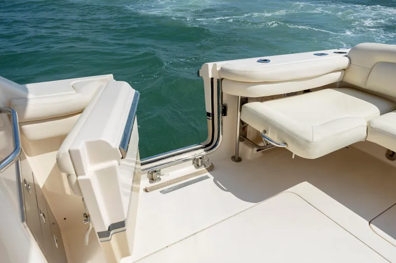 Slide: The Image of 2015 Grady-White Freedom 375 boat interior with open transom door and cushioned seating. - 19