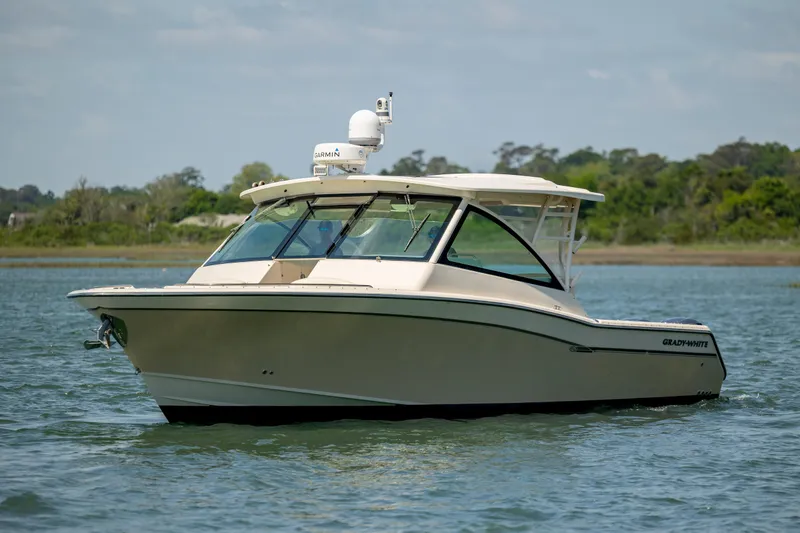 Slide: The Image of 2015 Grady-White Freedom 375 boat on calm water, side view. - 2