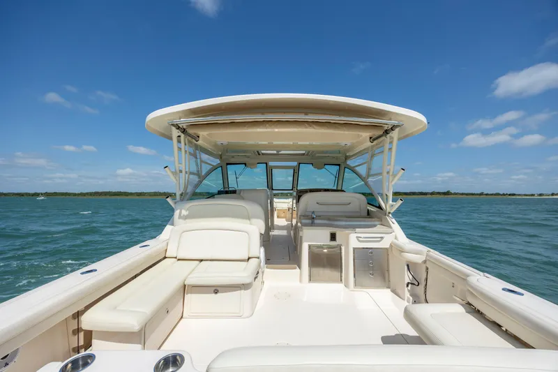 Slide: The Image of 2015 Grady-White Freedom 375 boat on open water under clear blue sky. - 22