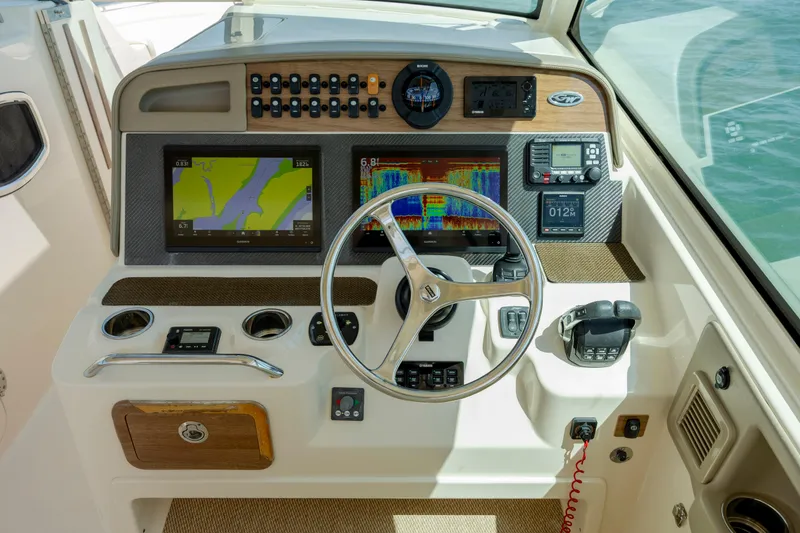 Slide: The Image of Helm of 2015 Grady-White Freedom 375 boat with navigation and control systems. - 26