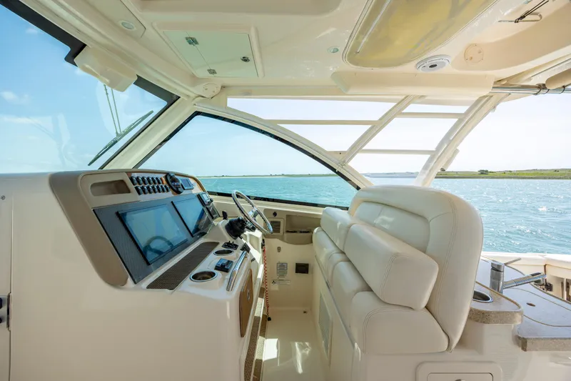Slide: The Image of Interior of 2015 Grady-White Freedom 375 boat with modern dashboard and seating. - 27