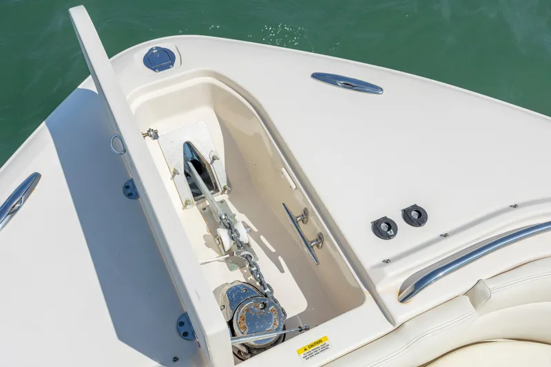 Slide: The Image of 2015 Grady-White Freedom 375 boat anchor compartment with chain, open lid, and sleek design. - 29