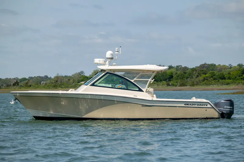 Slide: The Image of 2015 Grady-White Freedom 375 boat on calm water, side view. - 3