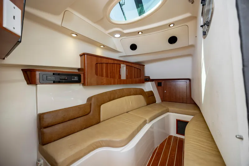 Slide: The Image of Interior of 2015 Grady-White Freedom 375 boat with elegant seating and wood accents. - 31