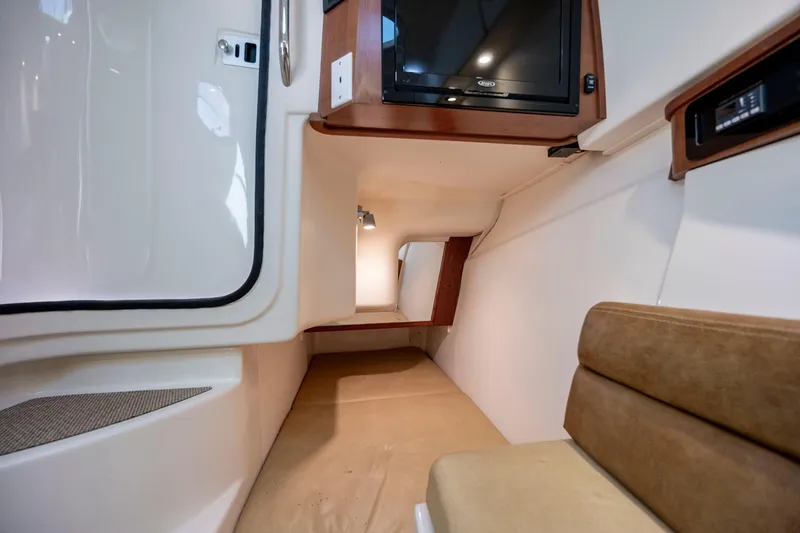 Slide: The Image of 2015 Grady-White Freedom 375 cabin interior with TV and seating area. - 33