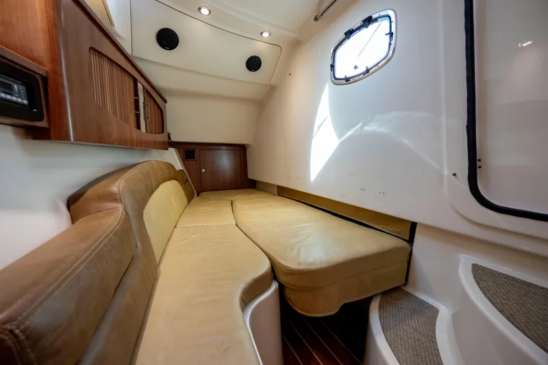Slide: The Image of 2015 Grady-White Freedom 375 cabin interior with beige seating and wooden accents. - 35